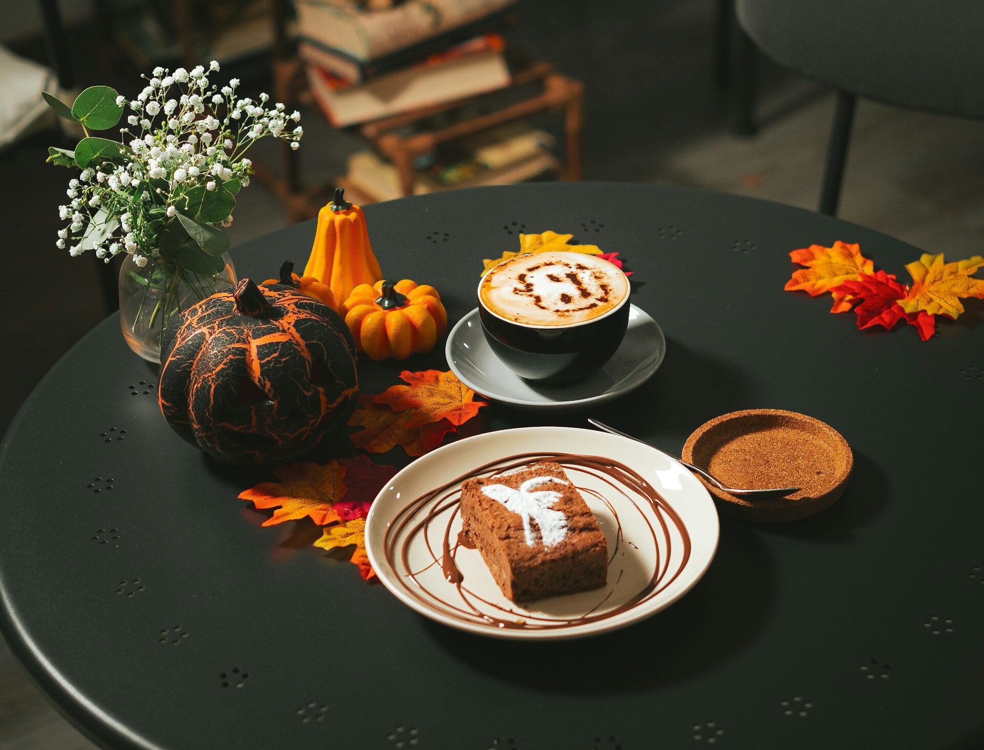 a table topped with a plate of cake and a cup of coffee