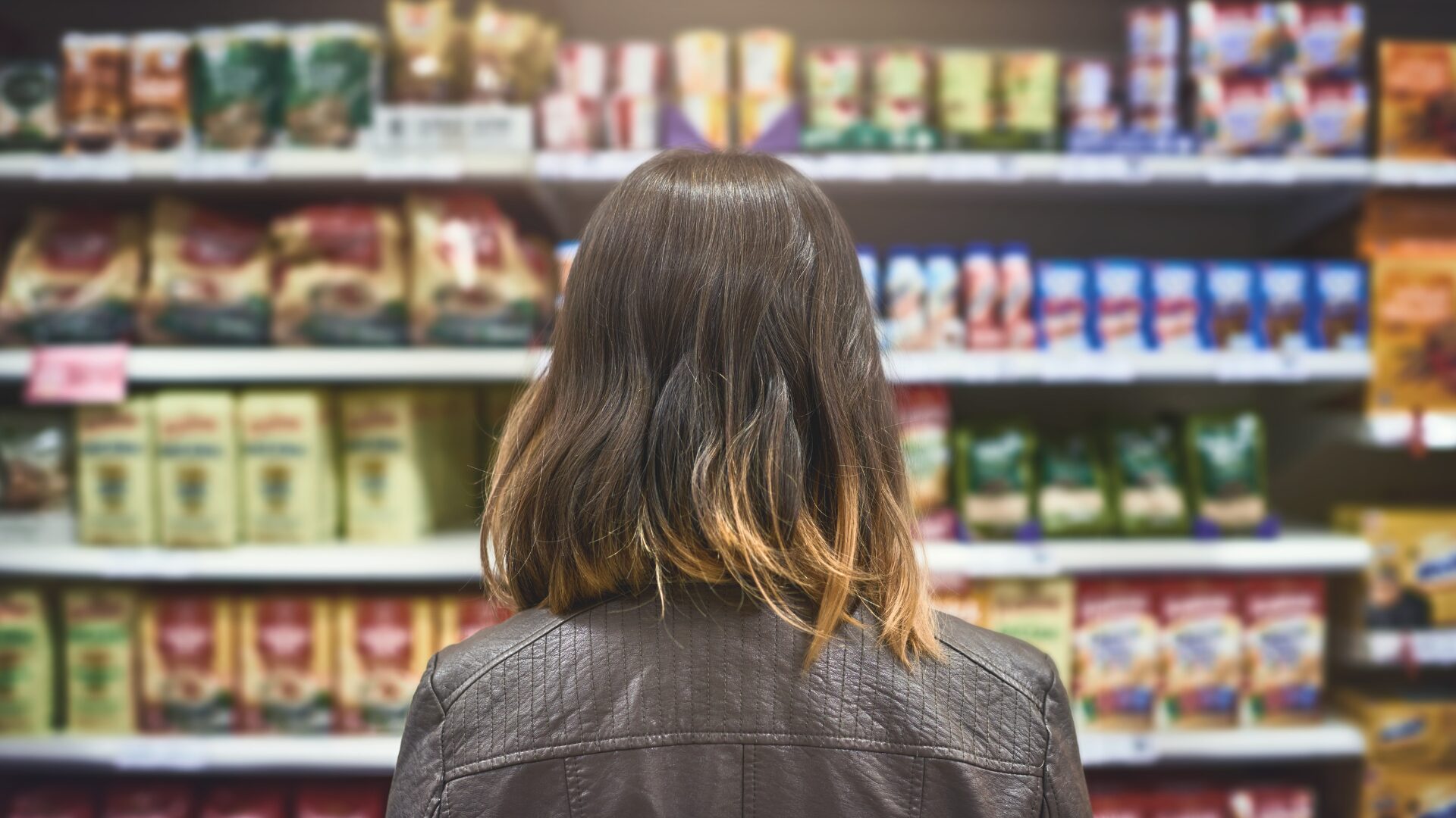 Woman Looking at Private Label on Shelf