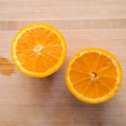 sliced orange fruit on brown wooden table