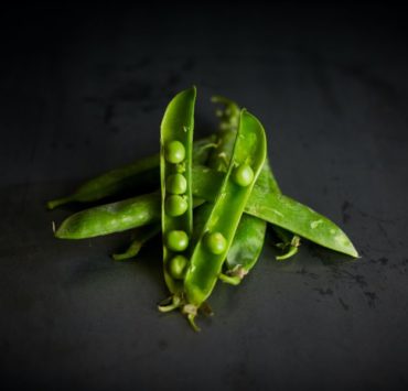 green peas on black surface