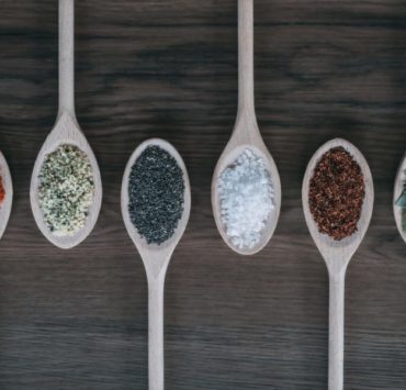 assorted-color spoons with spices