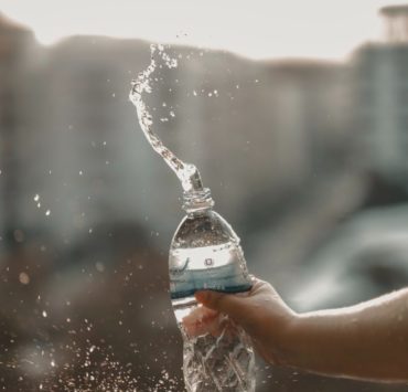 white and blue labeled disposable bottled water