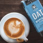 cup of latte beside oat barista box