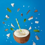 brown and white cake with white cream and green leaves on top