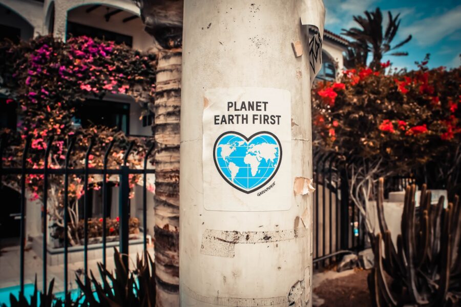 sustainability, Planet Earth First signage sticked in gray post outdoors