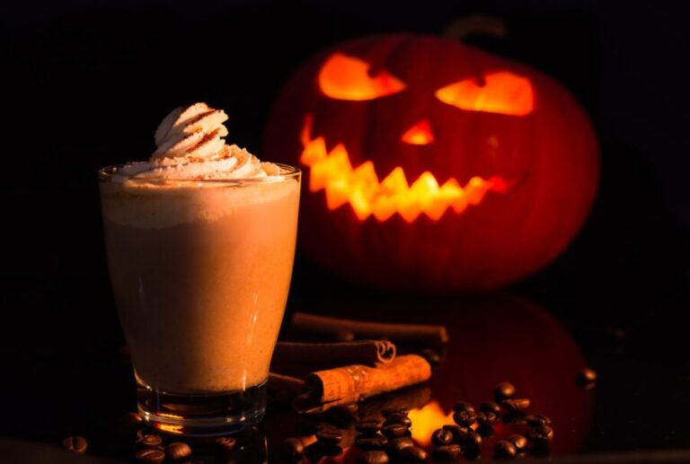 pumpkin spice, jack o lantern with chocolate drink on brown wooden table