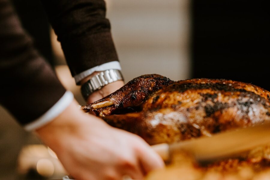 person holding white ceramic plate with grilled meat