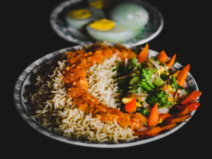 rice with sliced lemon and green vegetable on plate, global food, international cuisine, adventurous eaters
