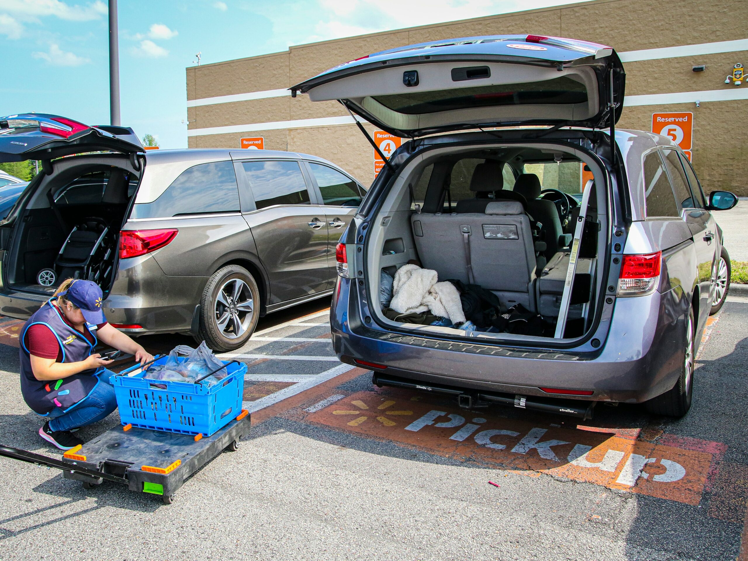 silver suv with blue plastic crate