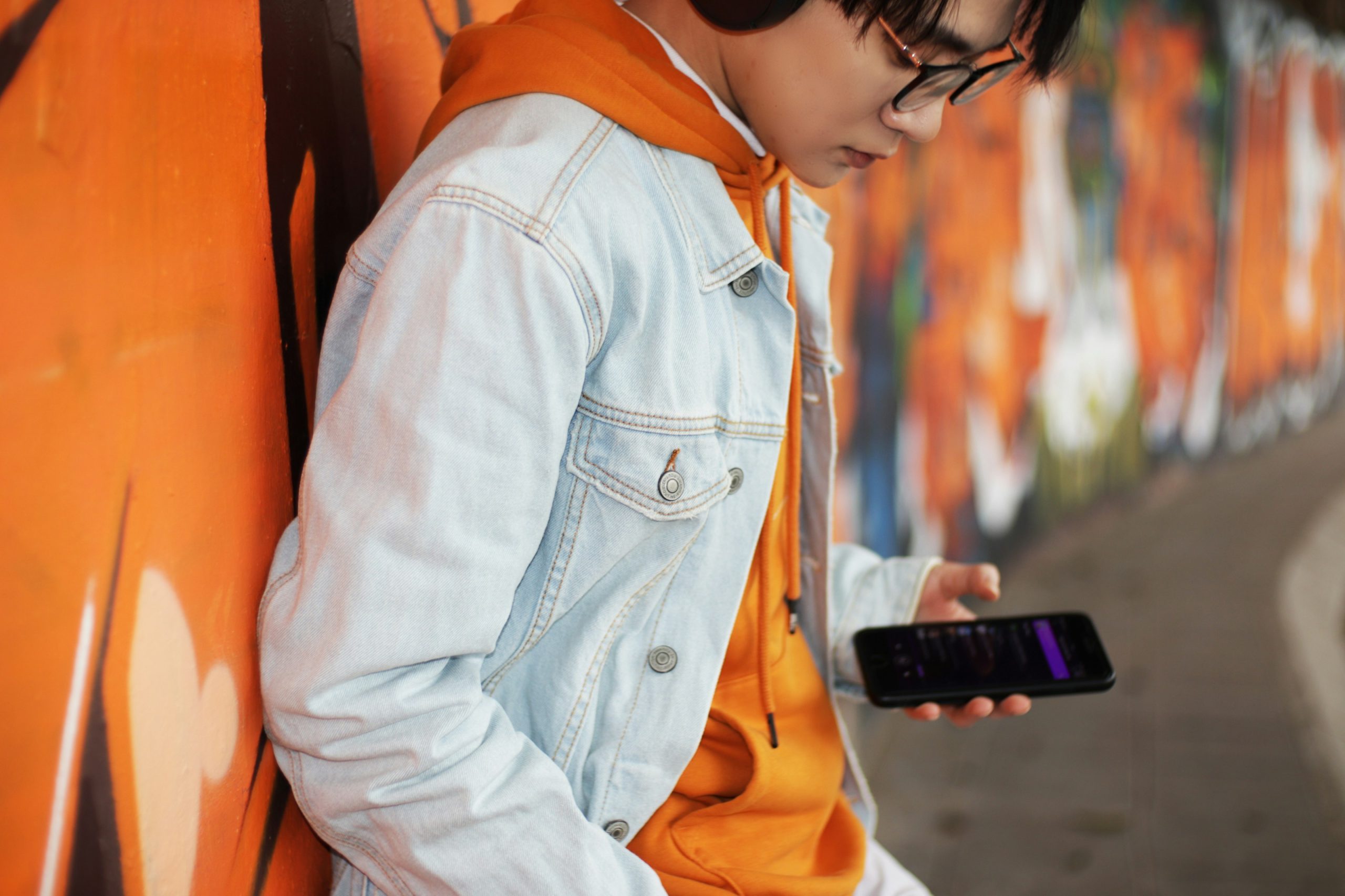 woman in white jacket holding smartphone