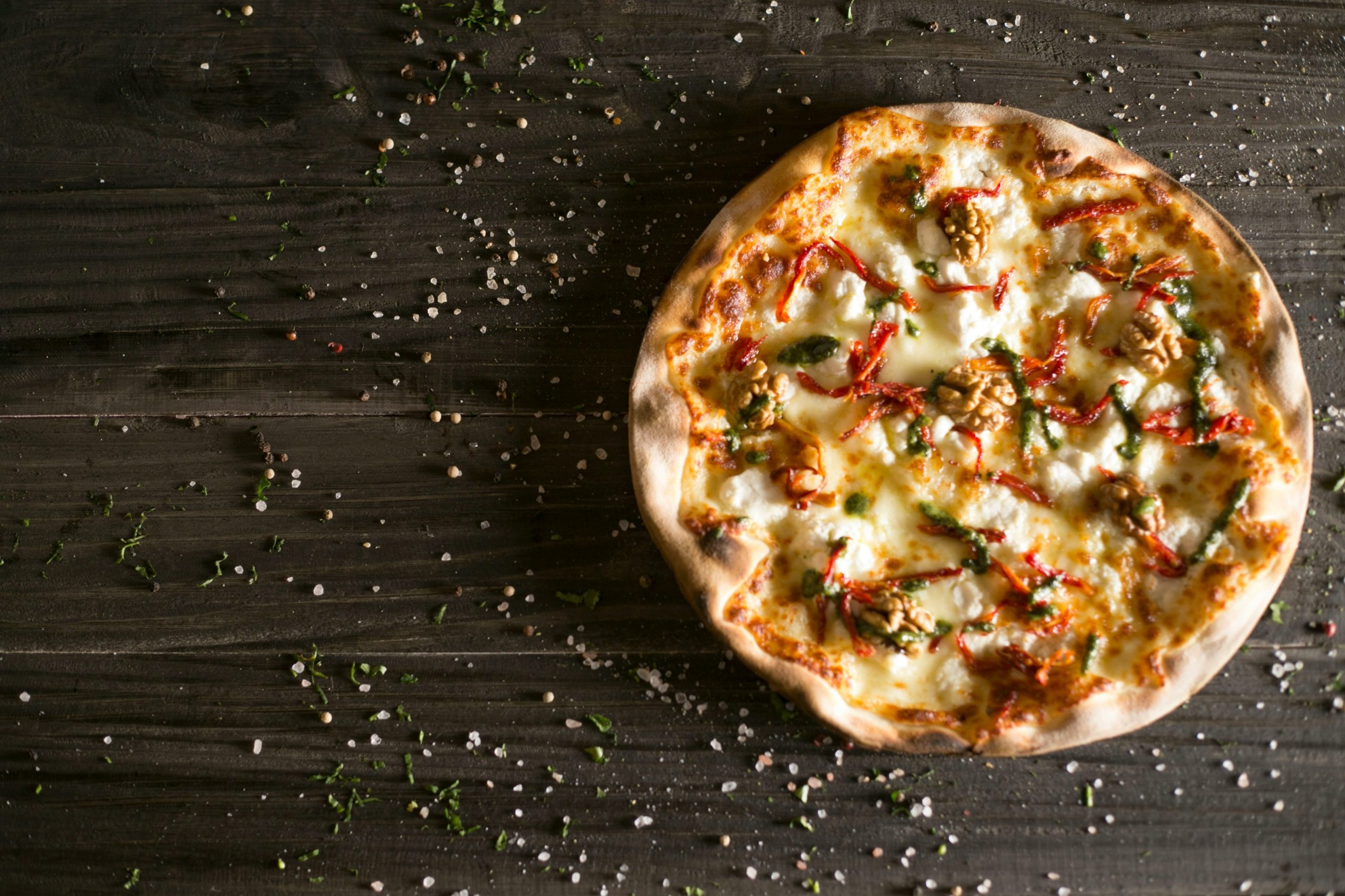 pizza with cheese and green leaves