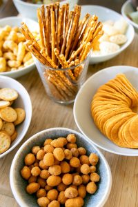 a wooden table topped with bowls of food