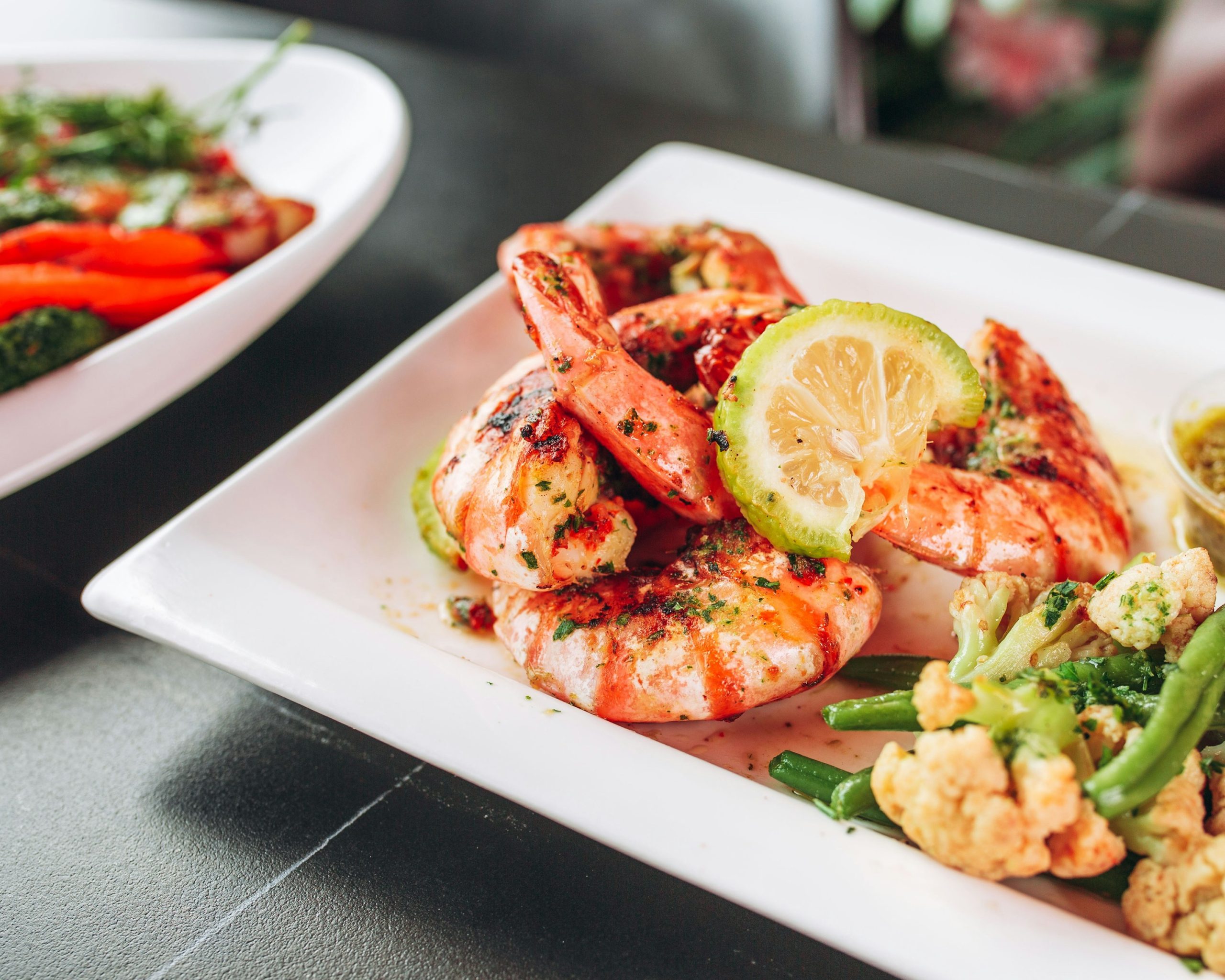 a white plate topped with shrimp and veggies
