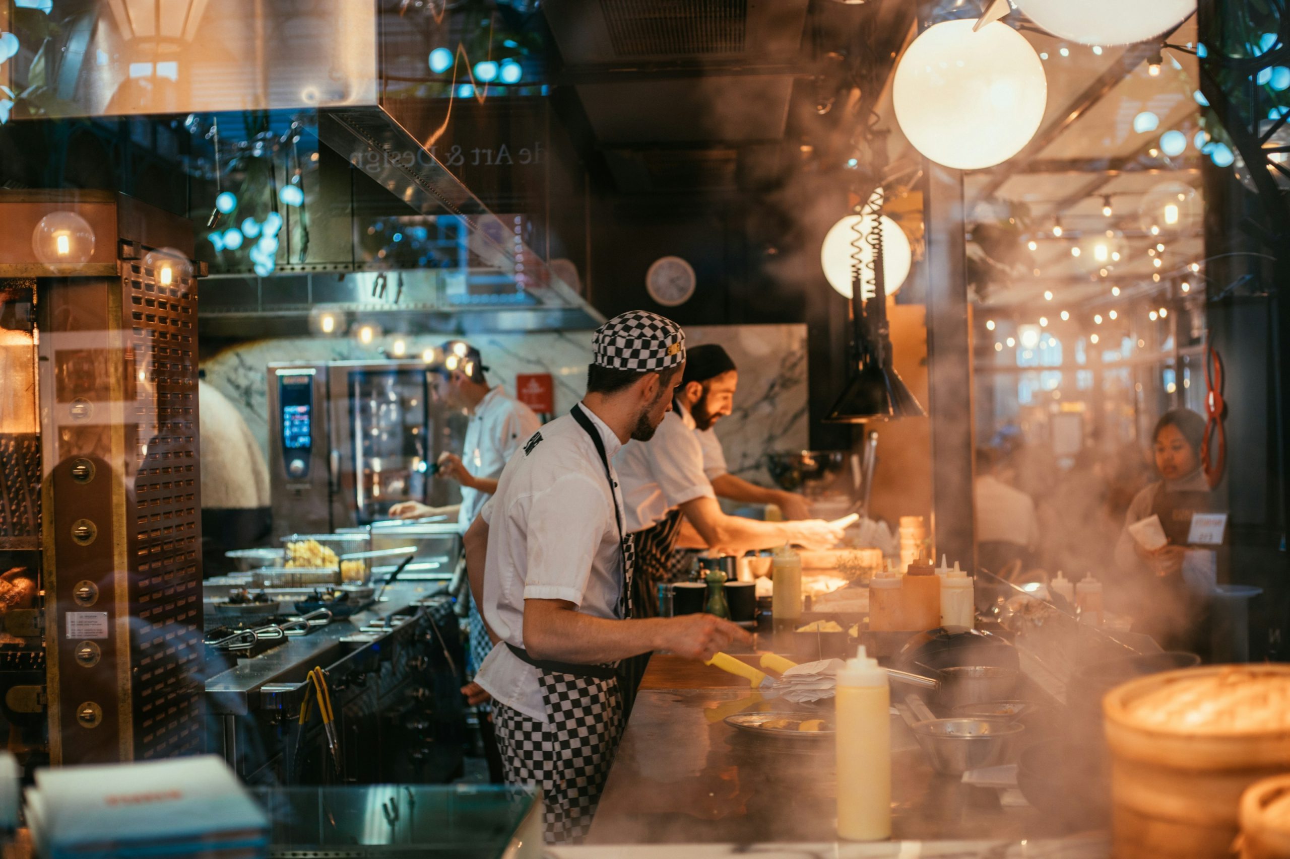 shallow focus photo of man wearing black and white apron